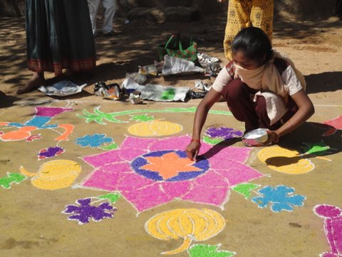 A girl draws a mandala